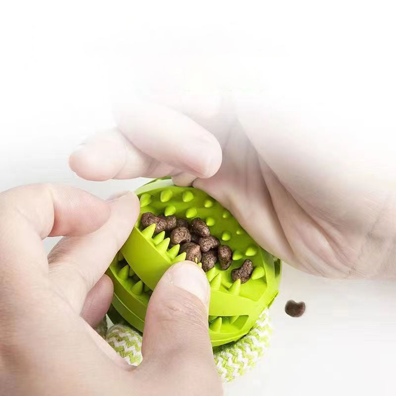 Green pet toy with food being filled, held by hands on a white background