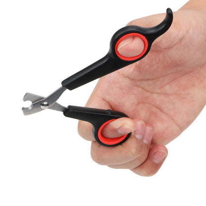 Hand holding a black and red nail clipper on a white background