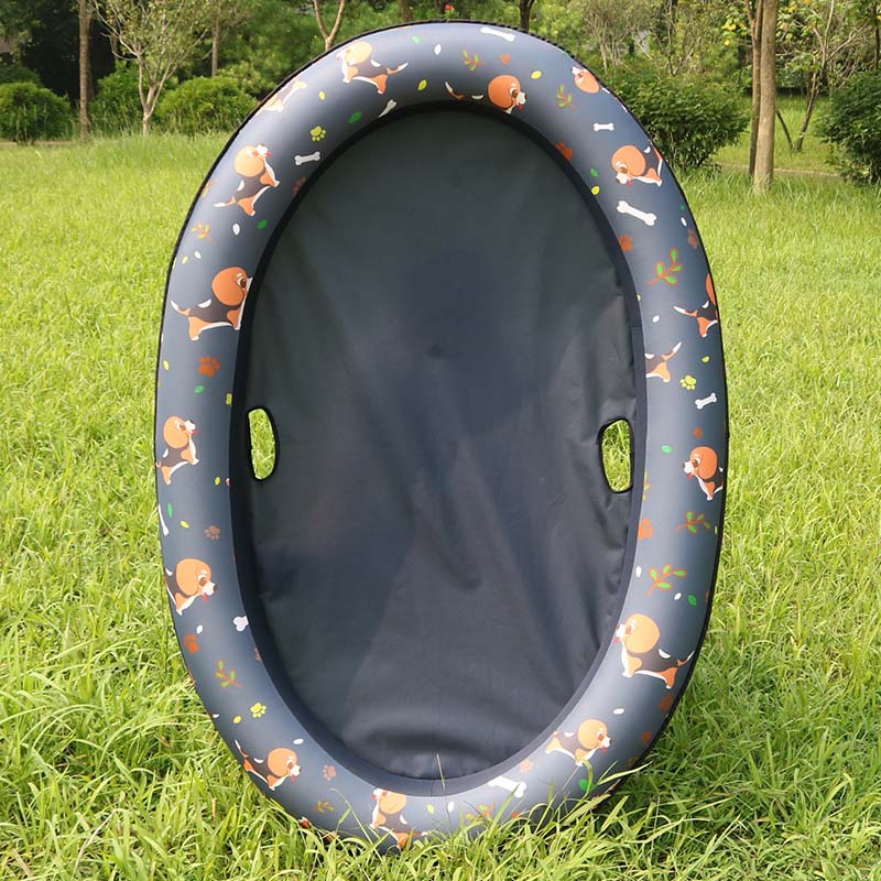 Inflatable pet seat with cartoon designs on a grassy field