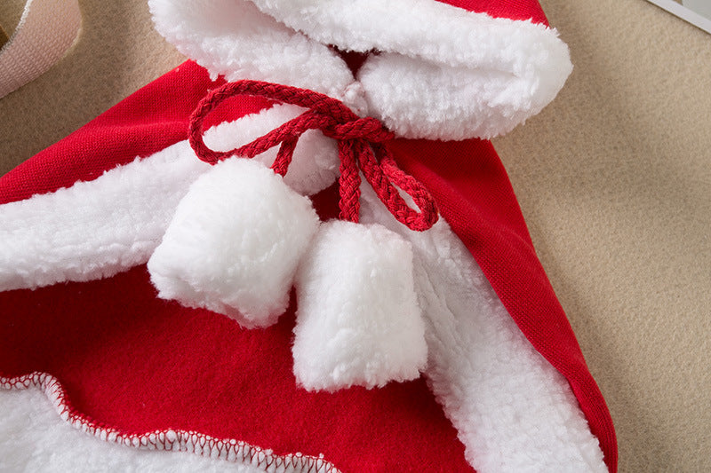 Close-up of a red and white fabric with tassels on a beige background
