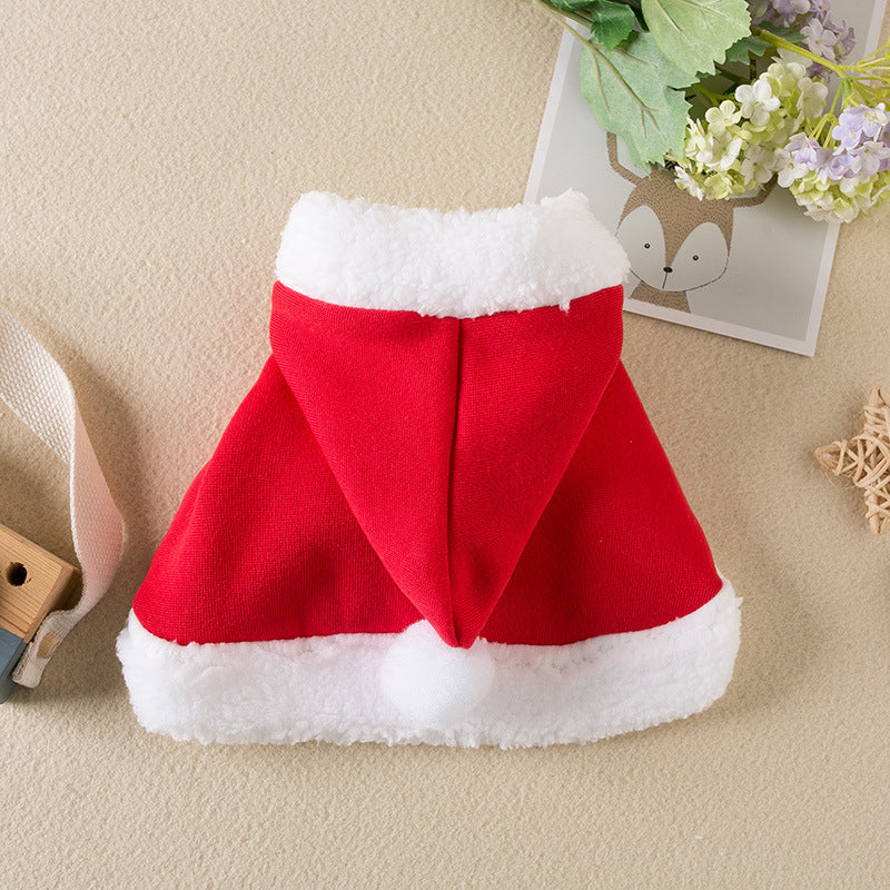 Red Santa hat with white trim on a beige surface