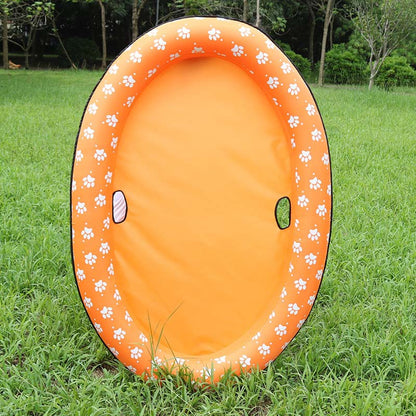 Orange inflatable pool with paw prints on a grassy background