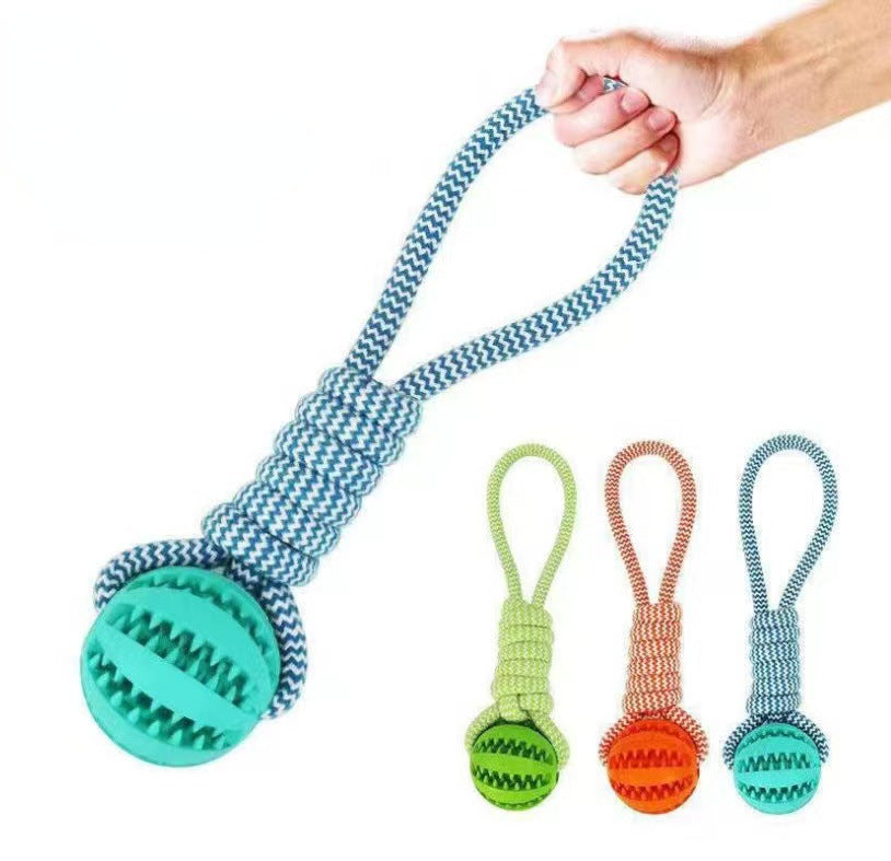 Dog toy with a ball and rope, held by a hand, with additional toys displayed below on a white background.