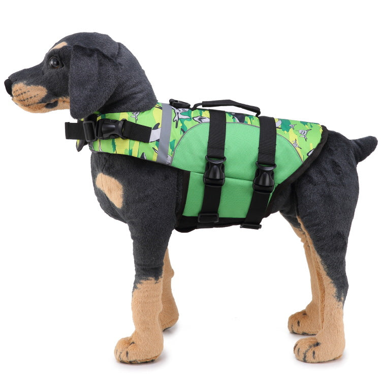 Dog wearing a green life jacket with a colorful pattern on a white background