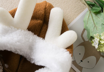 Close-up of a plush toy with white fur and brown body, featuring a cartoon character in the background.